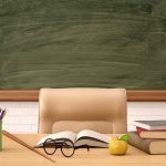 New Jersey’s Shocking Decision – Who’s Teaching The Kids Classroom desk with books, apple, and chalkboard