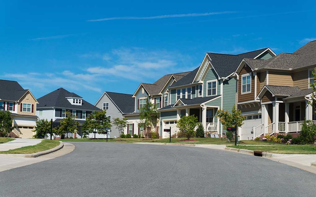 470746946 featured image Suburban street with colorful, modern houses.