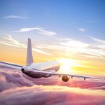 Travel Chaos Looms – Major ID Changes Coming in 2025 Airplane flying above clouds during sunset sky