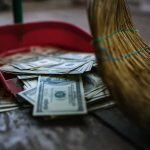 The Most Shocking Waste Yet – $160 Million Down the Drain Broom sweeping dollar bills into red dustpan floor