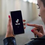 Major Catch in TikTok’s Return to App Store Person using TikTok app on smartphone