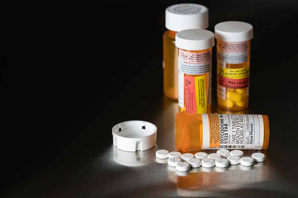 562612954 featured image Pills and prescription bottles on a dark surface