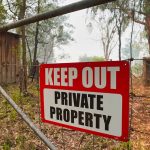 Land Grab Exposed – Town Secretly Seizes Family’s Land Red Keep Out Private Property sign on gate