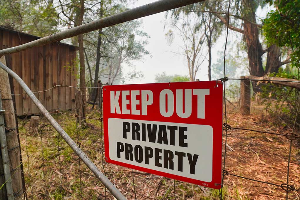 1605784459 featured image Red Keep Out Private Property sign on gate