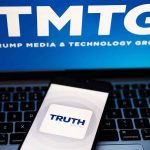 "TMTG and Truth Social logos on screen and phone."