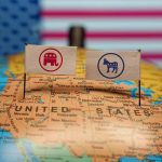 Republican and Democratic flags on USA map background.