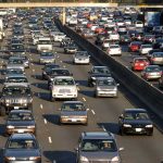 Car Lovers Win – Look What’s Coming Back! Heavy traffic on a multi-lane highway.