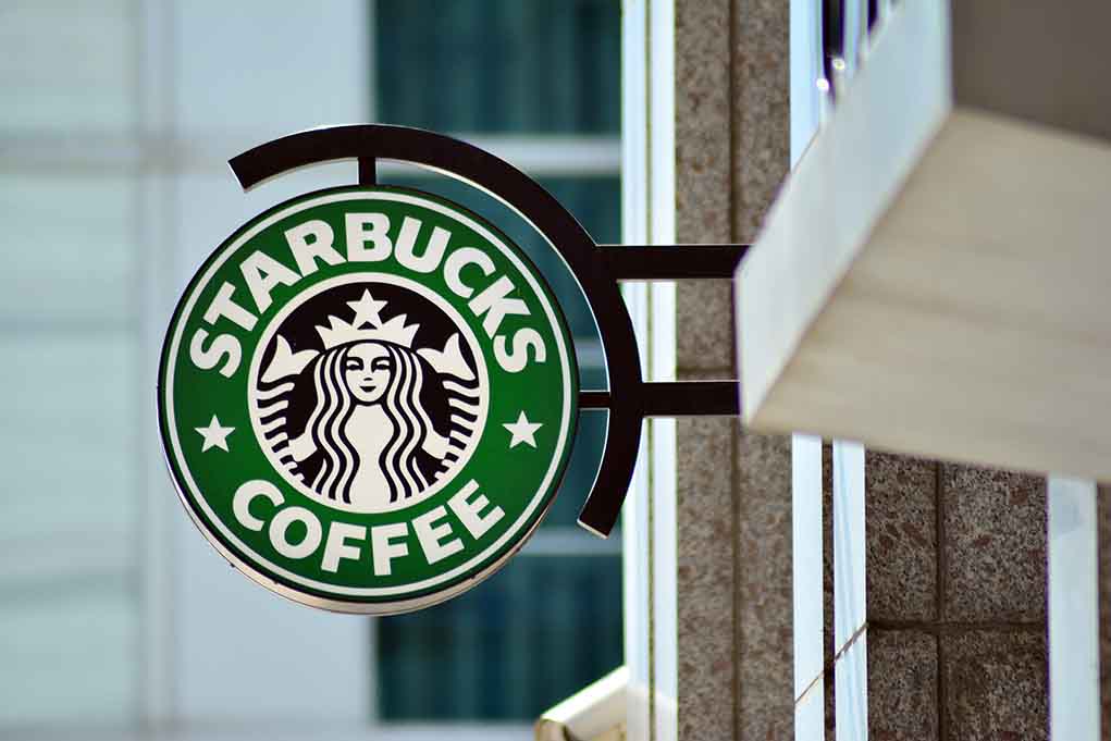 Starbucks coffee shop sign on building.