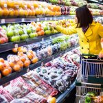Woman shopping for fruit in a grocery store