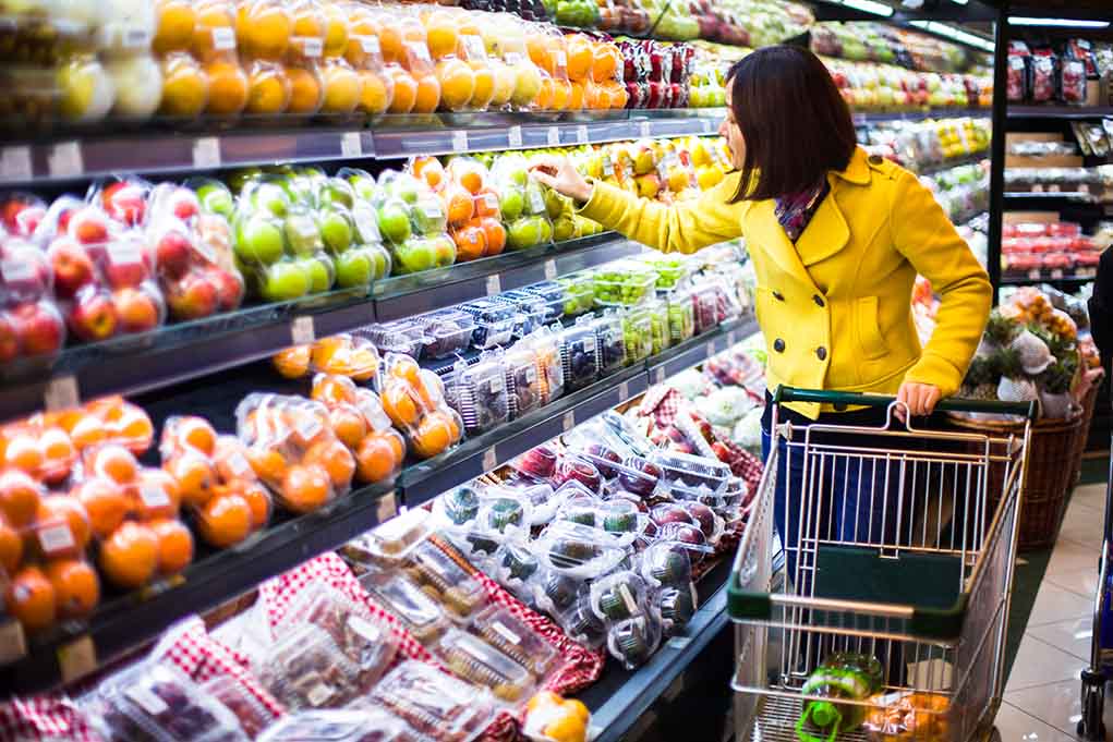 Woman shopping for fruit in a grocery store