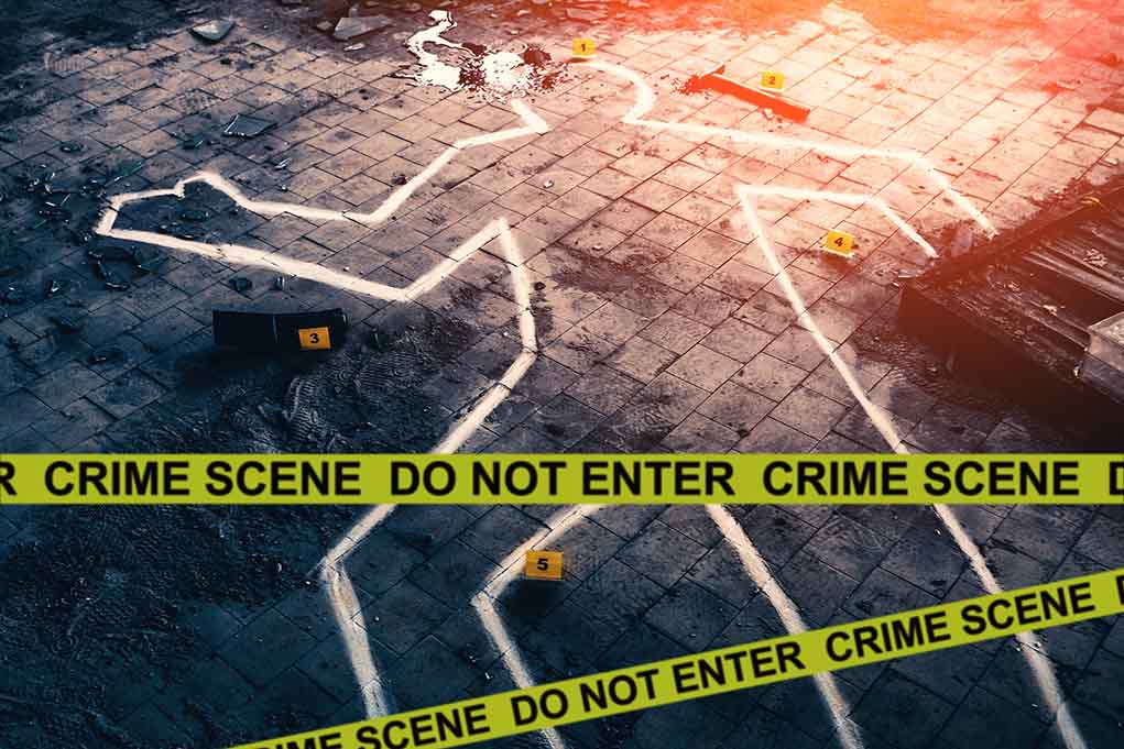 Chalk outline at a crime scene with evidence markers
