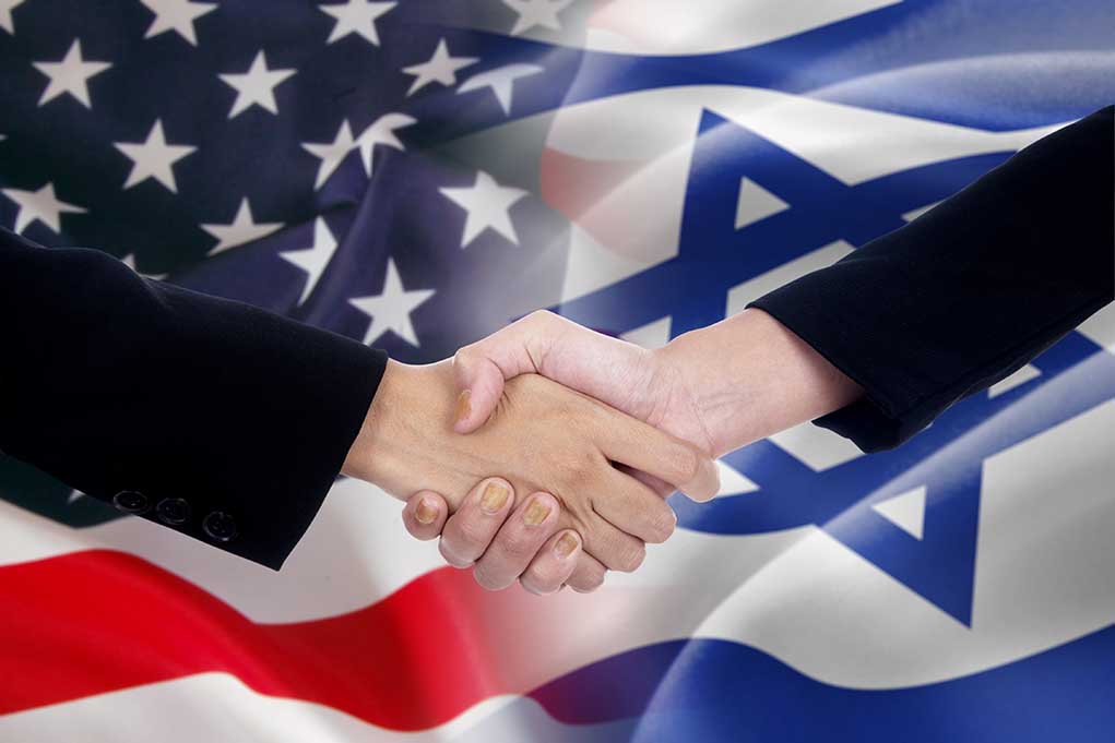 313845923 featured image Handshake in front of US and Israeli flags