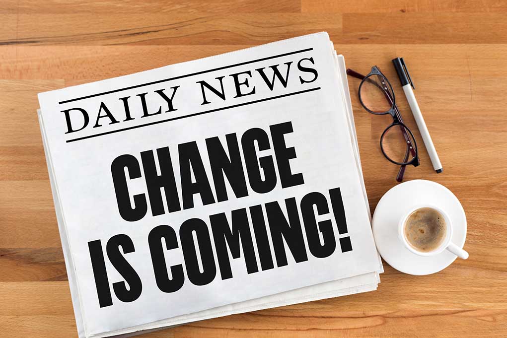 Newspaper headline Change Is Coming on table