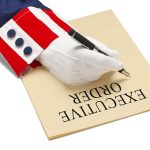 Deadly Road Risk Crushed by Trump Order Gloved hand writing executive order labeled paper