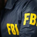 $1 Billion Hospital Scandal Under FBI Investigation Person wearing FBI jacket with yellow lettering