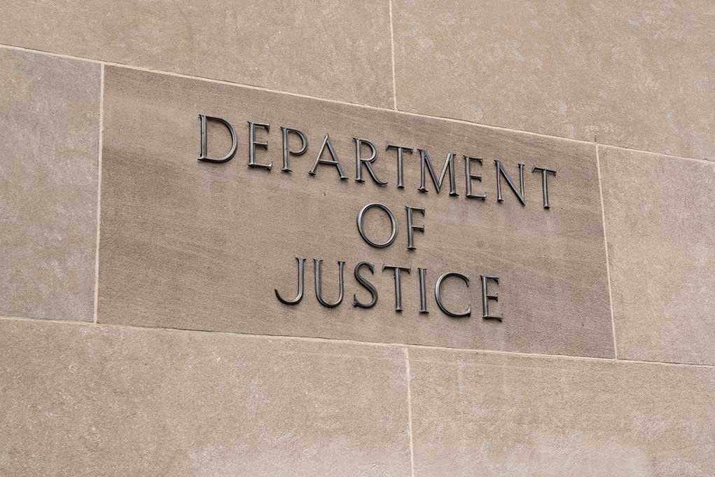 Department of Justice building sign on wall