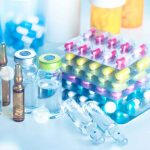 Hidden Deal Could Disrupt Drug Industry Forever Vials and blister packs of pills on table