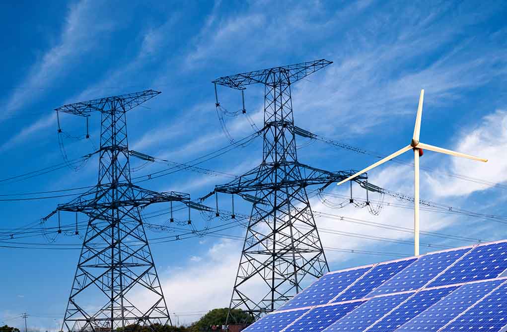 Power lines solar panels and wind turbine against sky