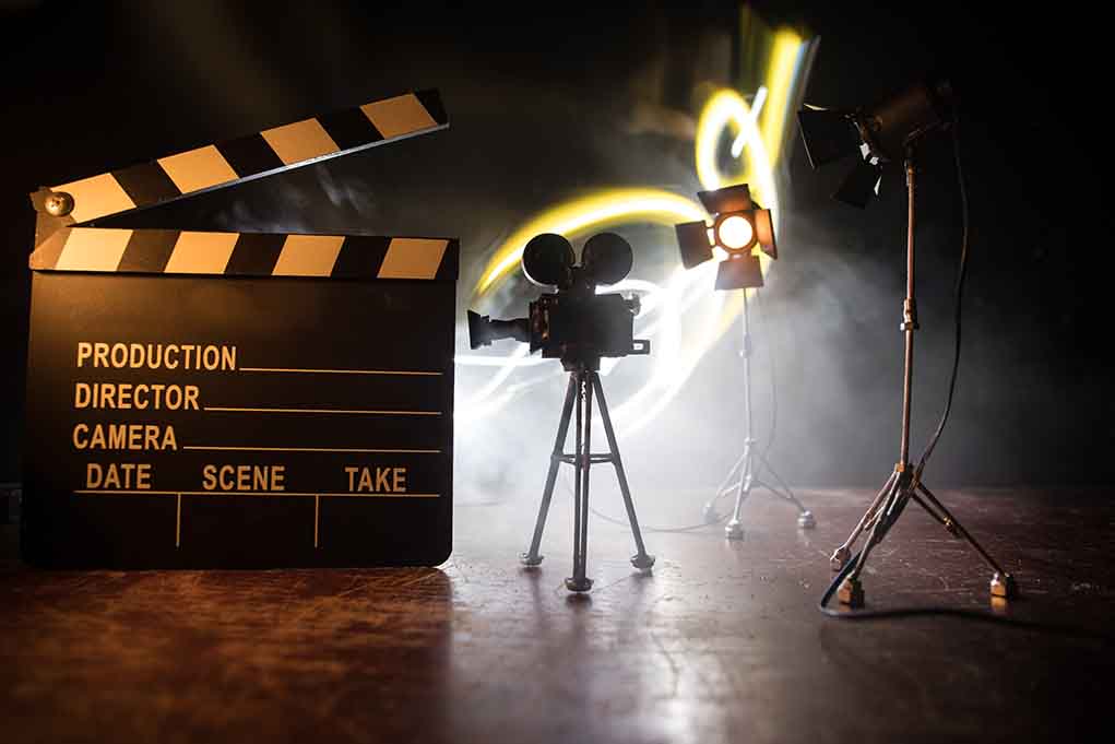 Film set with clapperboard camera, and lighting