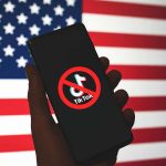 TikTok Ban Deadline: President Trump Contemplates Strategic Extension Phone displaying TikTok ban symbol in front of flag