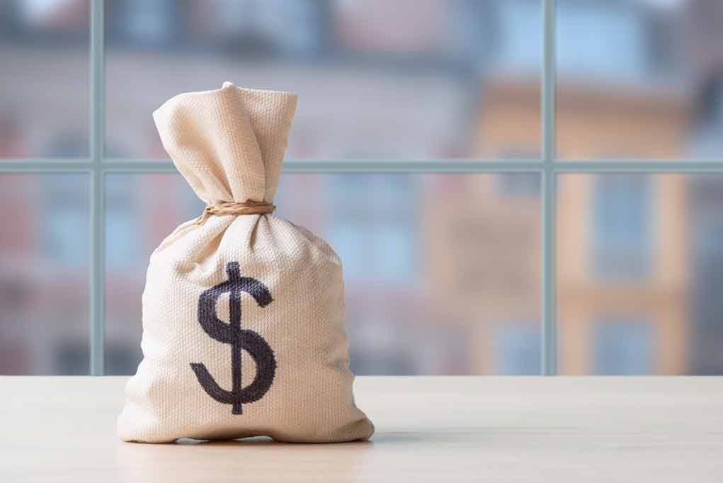 Money bag wit0000000000000000000000000000000000000h dollar sign on table