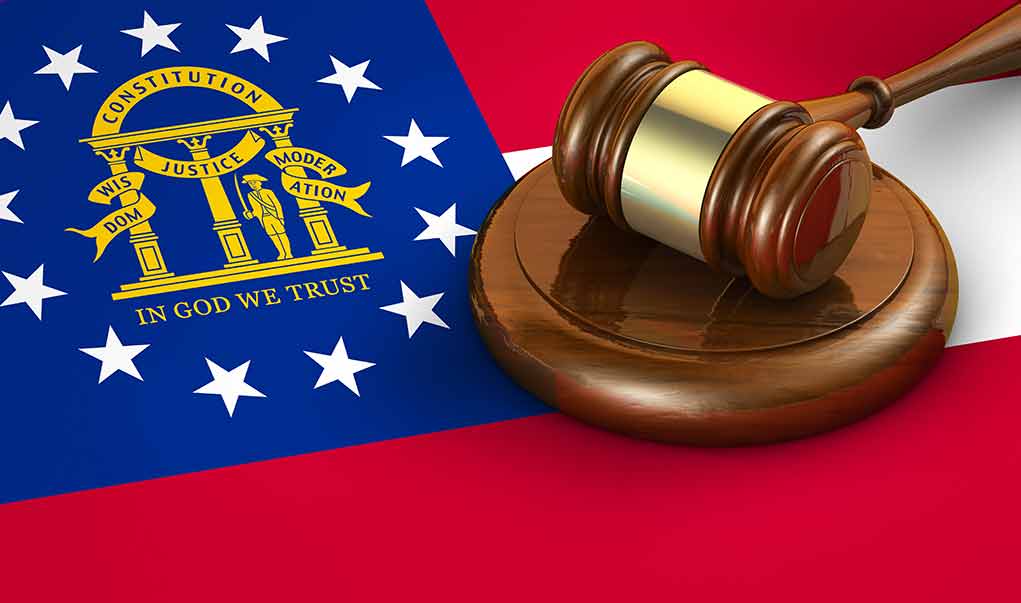 Georgia flag and judges gavel on wooden base