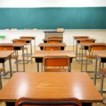 New Texas Initiative Aims to Strengthen School Safety Measures in Emergencies Classroom with wooden desks and empty green chalkboard