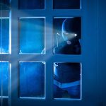 PARDONED Rioter BUSTED Again — Cops Storm In Masked figure peering through glass door at night