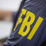Targeted — FBI Launches Major Ops Person wearing jacket with FBI in yellow letters