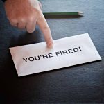 Academic Giant Toppled –EXPLOSIVE Allegations Envelope with YOU'RE FIRED and pointing finger