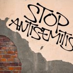 COLUMBIA EXPOSED: $400M in Funding REVOKED Stop antisemitism graffiti on a worn brick wall