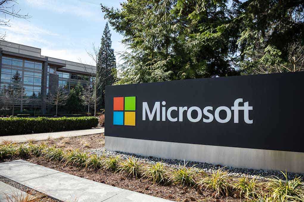 Microsoft sign with office buildings and trees