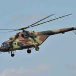 Military Disaster STRIKES Again — What Went Wrong? Camouflage military helicopter in flight against blue sky