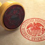 Federal Reserve stamp and wooden stamp on paper
