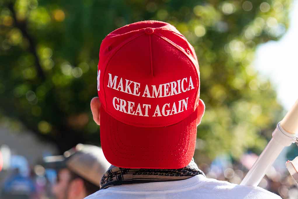 Red Make America Great Again hat on persons head