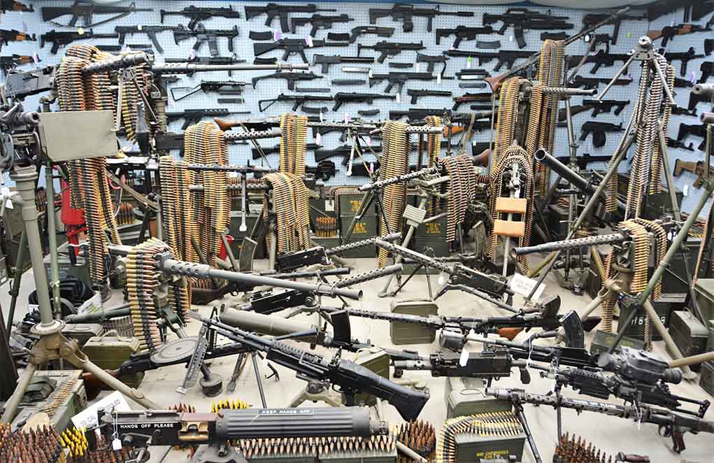 Room filled with various firearms and ammunition belts