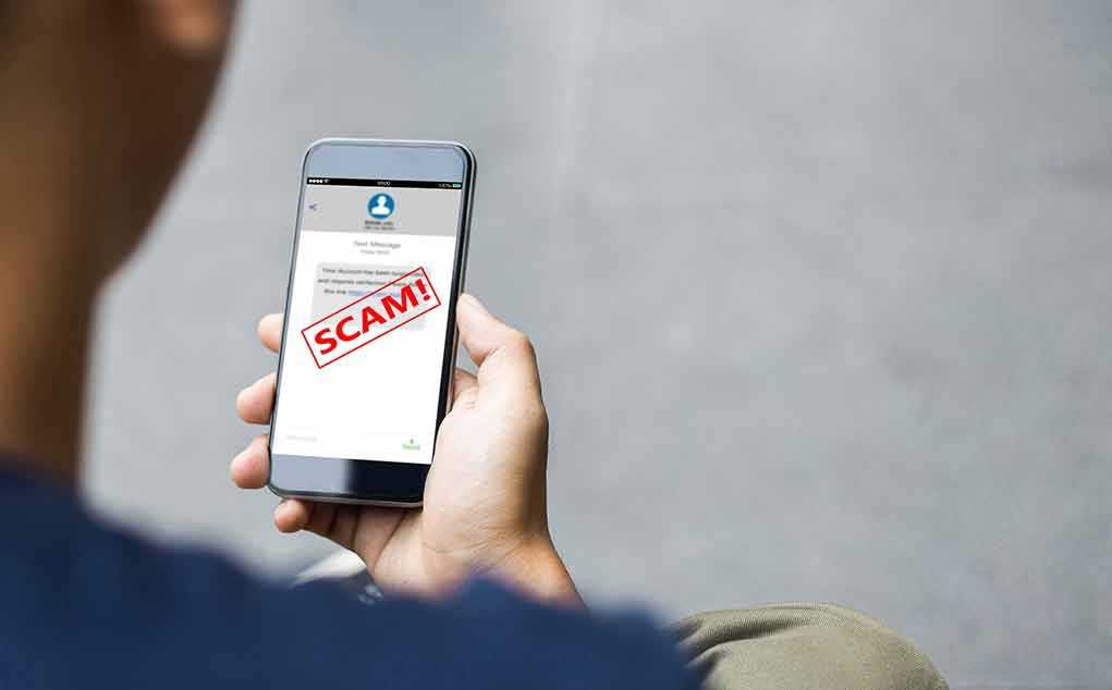 Person reading a scam message on a smartphone