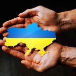 Hands holding Ukraine map with flag design