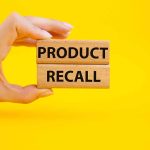Deadly Listeria Threat Triggers Another Recall Hand holding Product Recall blocks on yellow background