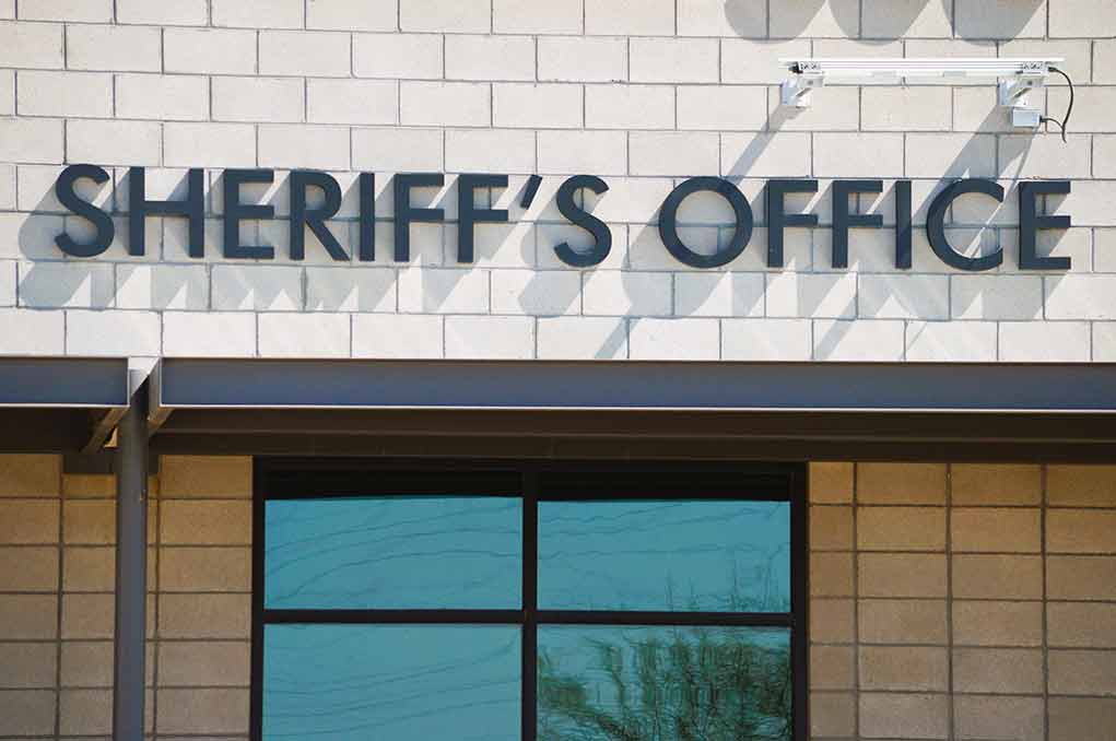 Sheriffs Office sign on brick building faade