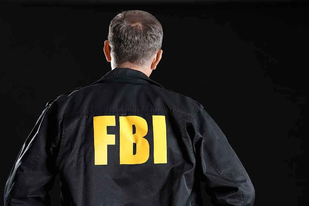 Person wearing jacket with FBI printed on back