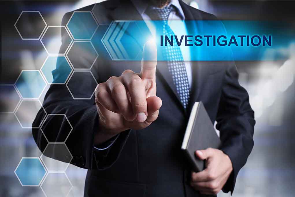 370333907 featured image Man in suit pointing at Investigations text