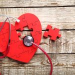 Heart Attack Deaths Plunge — But Something Worse Rising Red heart puzzle with stethoscope on wooden background
