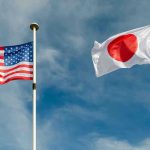 25% Tariff Threat: Japan’s Economic Crisis USA and Japan flags flying on flagpoles