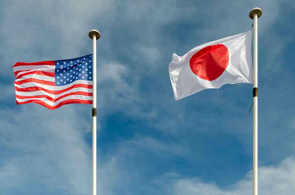 1052272007 USA and Japan flags flying on flagpoles