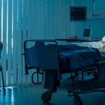 Healthcare BOMBSHELL: Americans Unprepared Woman sitting beside hospital bed at night