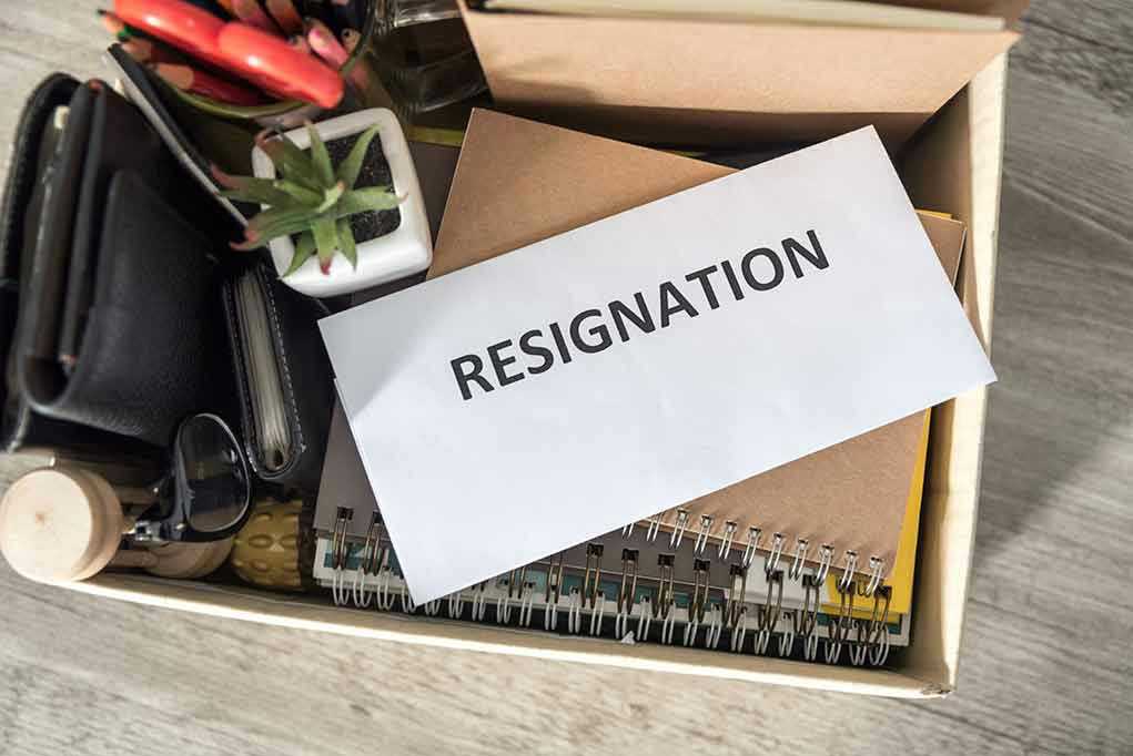 Envelope labeled resignation in a box of office items