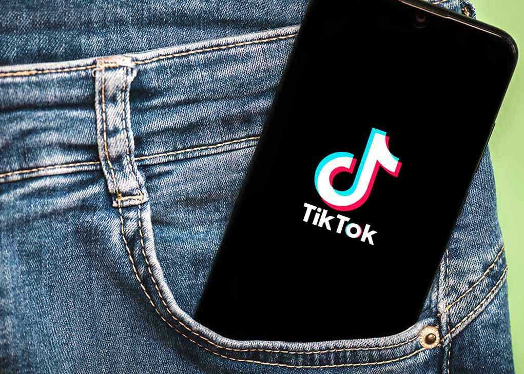 Phone with TikTok logo in jeans pocket