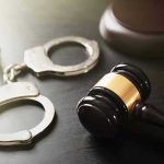 Twin Homicide Stuns City—DNA Leads to Charges Handcuffs and judge's gavel on the table