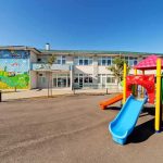 School Defies Parents—Uses Male Name Anyway Colorful playground slide in front of a building